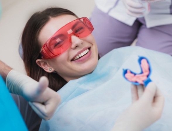 Smiling woman receiving fluoride treatment