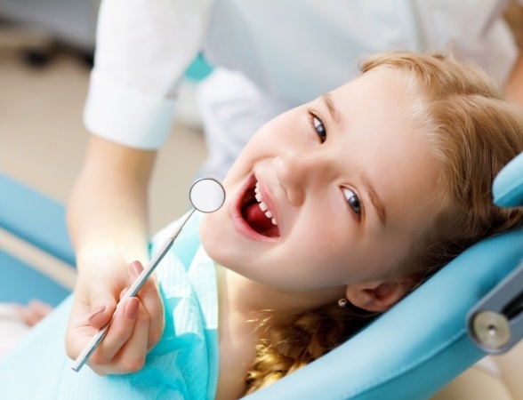 Child smiling during dental checkup and teeth cleaning for kids