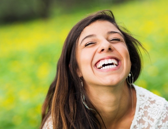 Woman sharing flawless smile designed by virtual smile design system