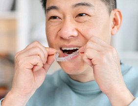 a man preparing to wear his Invisalign aligners