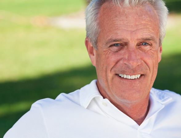 Senior man with a white shirt smiling