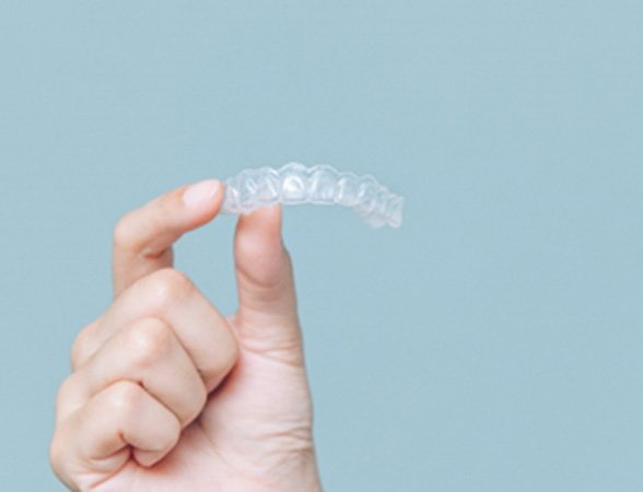 Patient holding Invisalign aligner