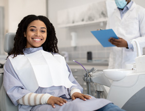 Woman smiling while sitting in treatment chair