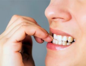 a person biting their fingernails