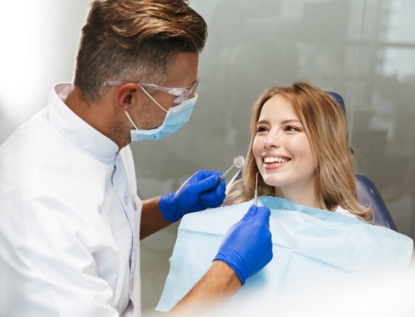 Dentist treating smiling dental patient