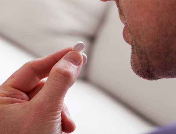 Patient taking oral conscious dental sedation pill