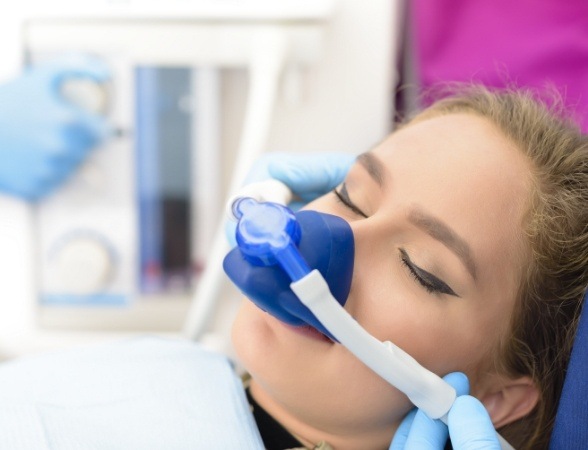 Woman with nitrous oxide sedation dentistry nasal mask in place during dental treatment