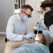 A dentist examines a woman's teeth during a check-up at Anthony Dillard, DDS Family & Cosmetic Dentistry.