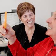 A smiling patient holds up a toothbrush, promoting dental health at Anthony Dillard, DDS Family & Cosmetic Dentistry.