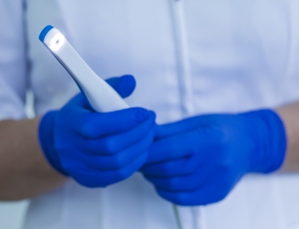 Dentist holding an intraoral camera