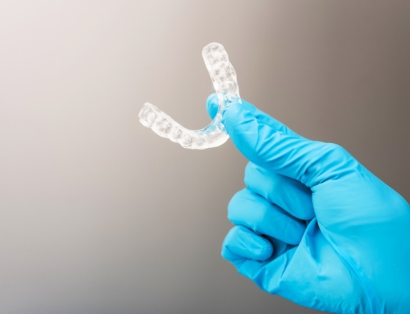 Hand holding a custom occlusal splint