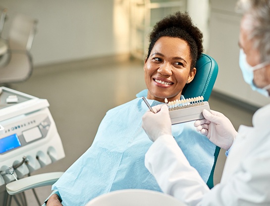 Woman smiling during veneers consultation with Carrollton cosmetic dentist