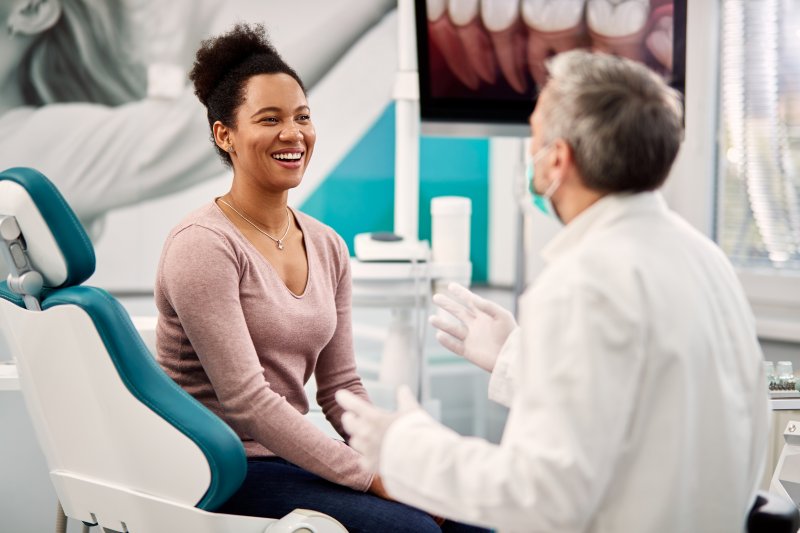 patient speaking with dentist about dental crown lifespan